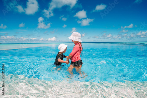 Adorable little girls playing in outdoor swimming pool © travnikovstudio