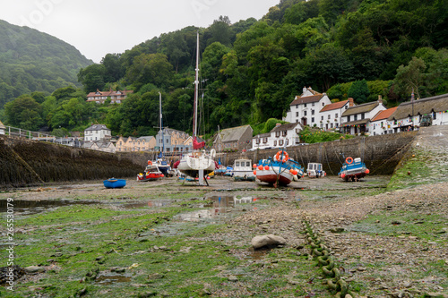 Lynmouth harbour in Devon at low tide with boats in the foreground