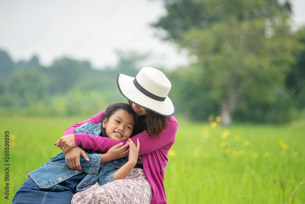 Asian mother hugging daughter in flower garden,Mum and adorable little cute child greeting ,proud and playing together outdoors.Happy family in mother's day concept,I Love you best mom. Asian mother hugging daughter in flower garden,Mum and adorable little cute child greeting ,proud and playing together outdoors.Happy family in mother's day concept,I Love you best mom.