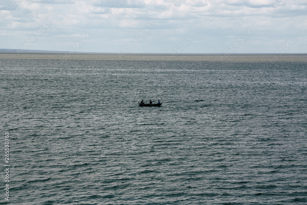 Fishermen in the sea on a small boat