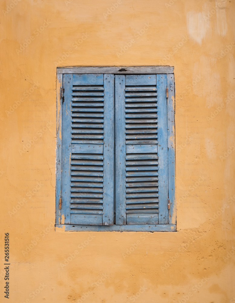 Retro window on the yellow wall in Hoi an, Vietnam
