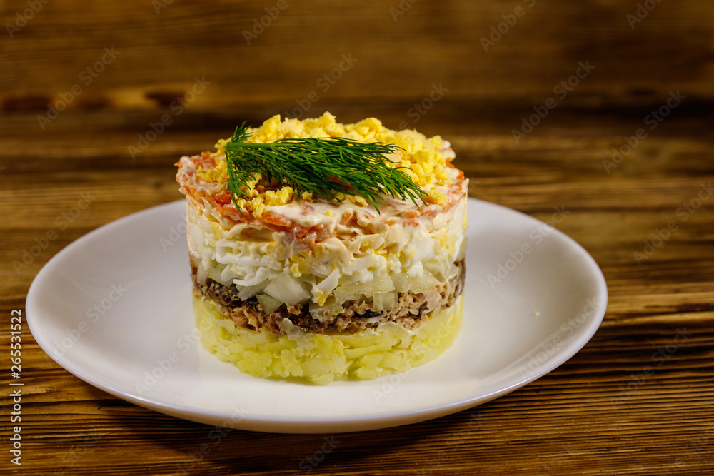 Traditional russian salad Mimosa on wooden table Traditional russian salad Mimosa on wooden table