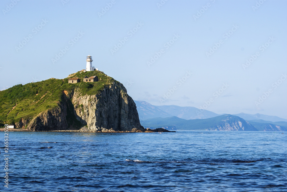 Cape Briner. Primorsky Krai.  lighthouse Rudny on top of a hill near the shore of the Japan sea