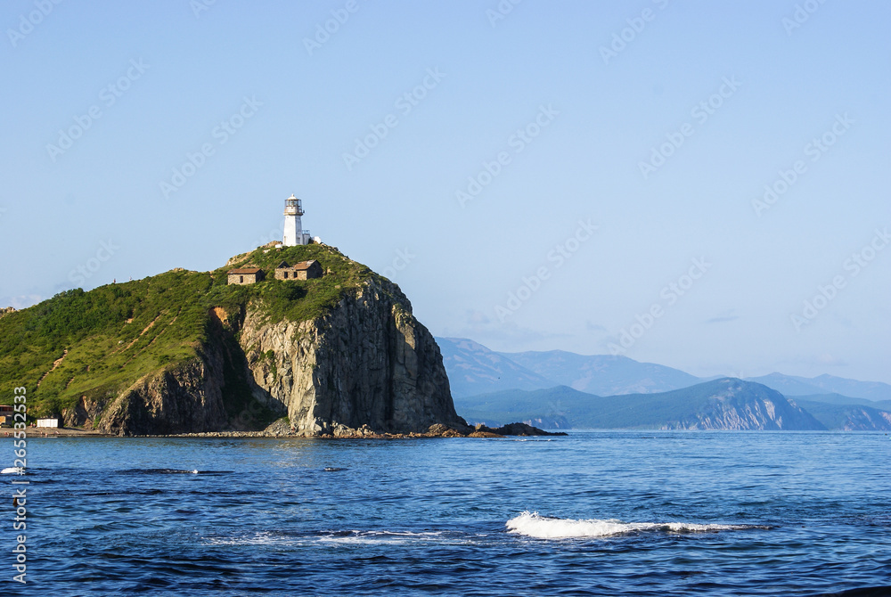 Cape Briner. Primorsky Krai.  lighthouse Rudny on top of a hill near the shore of the Japan sea