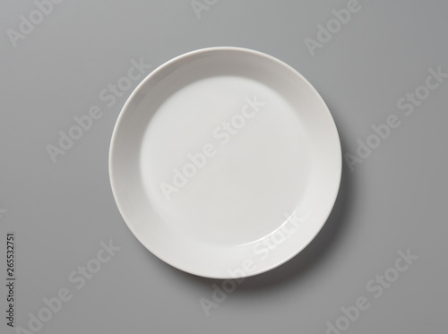 Top view empty white plate on grey background with shadow