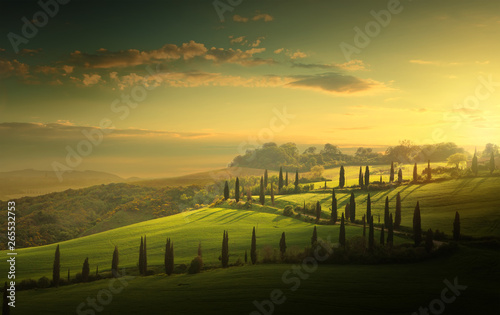 summer farmland and country road; tuscany countryside rolling hills