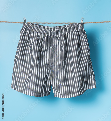 Men's boxer shorts hanging on rope