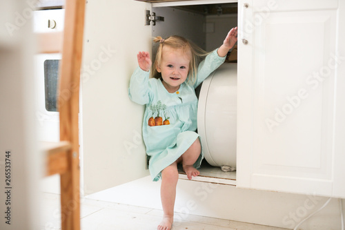 Kids playing hide and seek, blonde Toddler girl