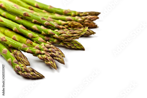 Bunch of fresh raw garden asparagus closeup on white background. Green spring vegetables.
