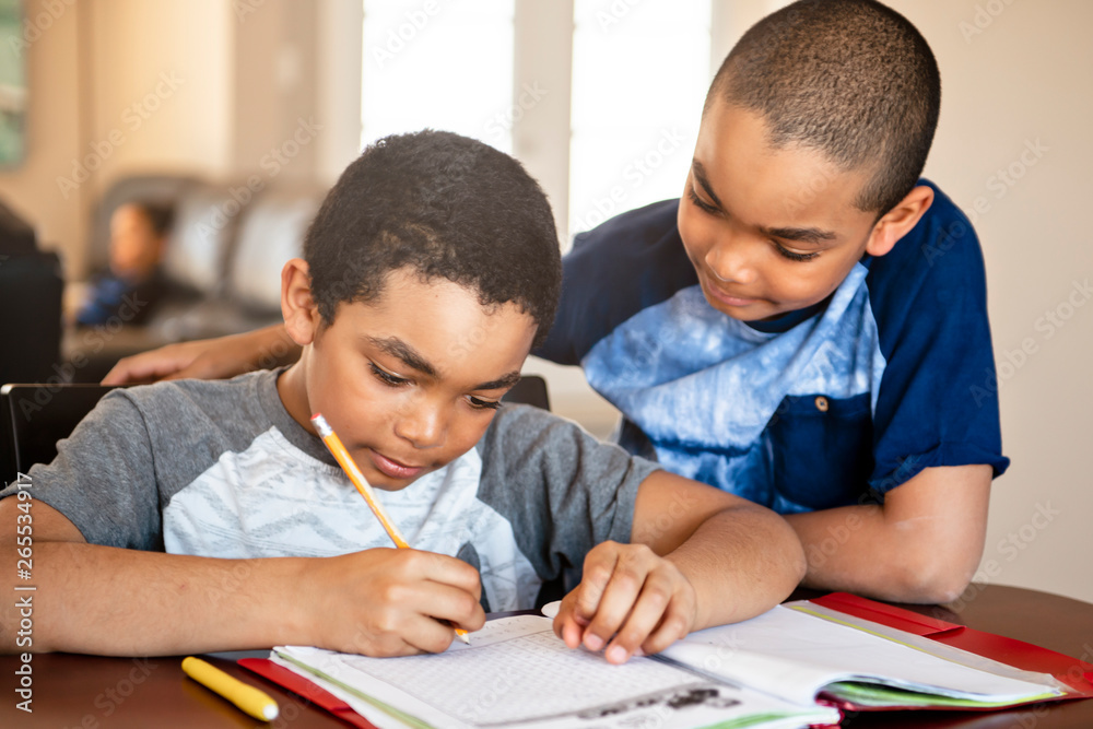 two black brother child doing homework at home two black brother child doing homework at home
