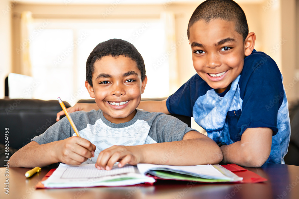 two black brother child doing homework at home two black brother child doing homework at home