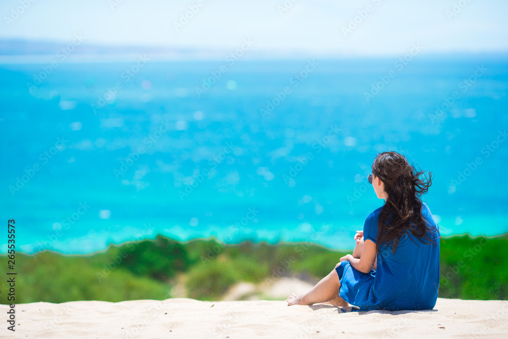 Young happy woman enjoy summer vacation on white sandy beach