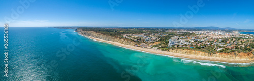 Aerial seascape, of Praia Porto de Mos (Beach and seaside cliff formations along coastline of Lagos city), famous destination in Algarve. South Portugal.