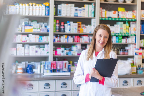 Smiling female pharmacist working in chemist shop or pharmacy. Female happy pharmacist chemist woman standing in pharmacy drugstore Free Download Smiling female pharmacist working in chemist shop or pharmacy. Female happy pharmacist chemist woman standing in pharmacy drugstore - GFXLoad