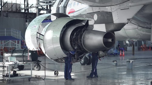 Maintenance of aircraft. Repair of the tail of the aircraft. The engineer repairing the aircraft.. 4k.