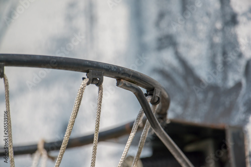 Closeup of basketball rim, net, and backboard - weathered street outdoor court