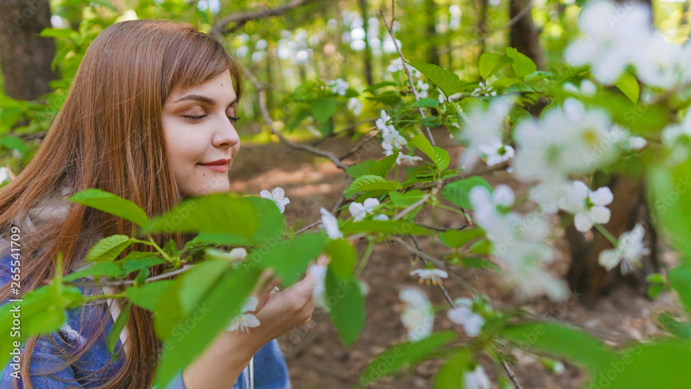 Young woman with gorgeous smile having fun in blooming garden. Female on natural background, wellness and fitness concept. Sensual blond girl walking in park Young woman with gorgeous smile having fun in blooming garden. Female on natural background, wellness and fitness concept. Sensual blond girl walking in park