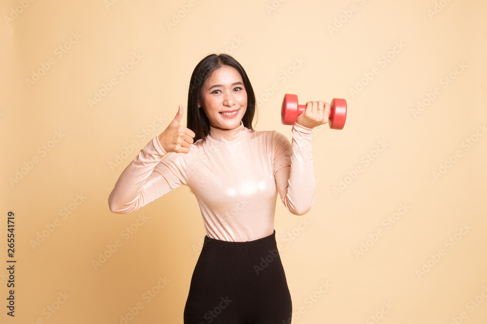 Healthy Asian woman thumbs up with dumbbells. Healthy Asian woman thumbs up with dumbbells.