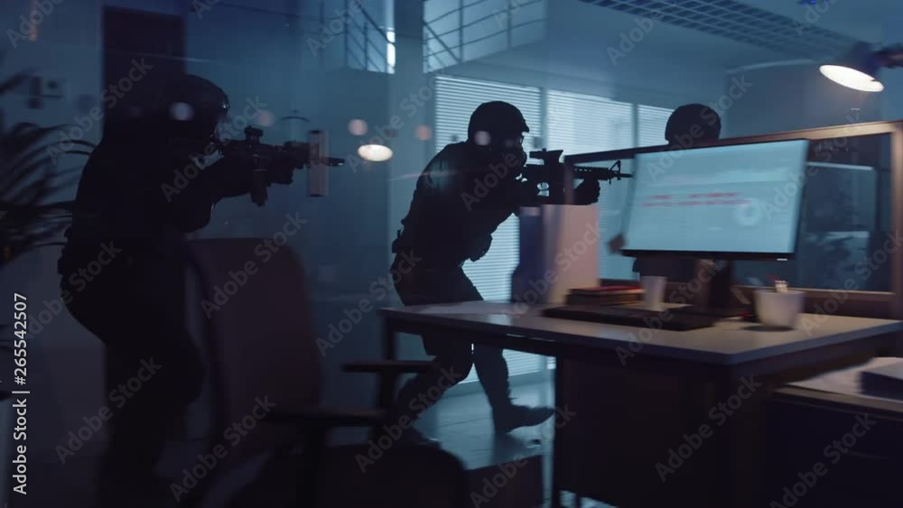 Masked Squad of Armed SWAT Police Officers Storm a Dark Seized Office Building with Desks and Computers. Soldiers with Rifles and Flashlights Move Forwards and Cover Surroundings. Masked Squad of Armed SWAT Police Officers Storm a Dark Seized Office Building with Desks and Computers. Soldiers with Rifles and Flashlights Move Forwards and Cover Surroundings.