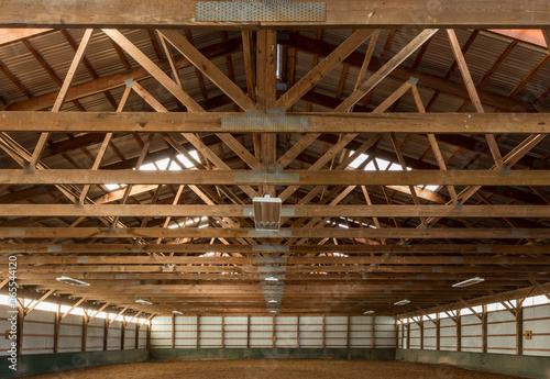 Wooden rafters in indoor horse riding ring