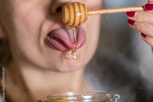 Woman eating fresh sweet honey