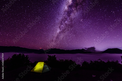 Milky Way galaxy over campsite in starry night sky photo