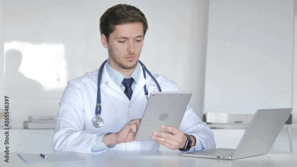 Young Doctor Using Tablet Computer Young Doctor Using Tablet Computer
