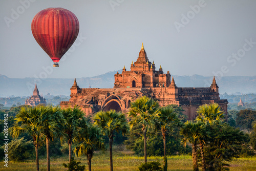 Hot air balloon flying over temple