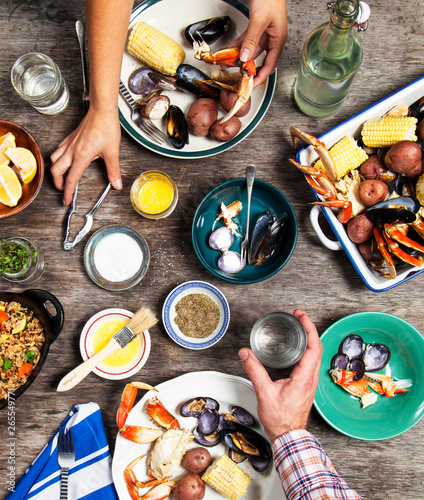 High angle view of hands at seafood dinner photo