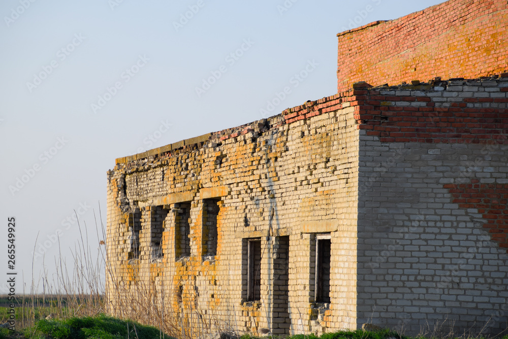 Old soviet brick abandoned building. Collapsing brick construction.