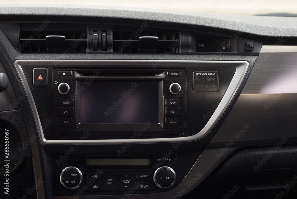 Modern car dashboard with multimedia screen. Interior detail.
