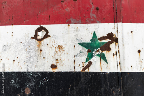 Syrian flag painting with bullet impact