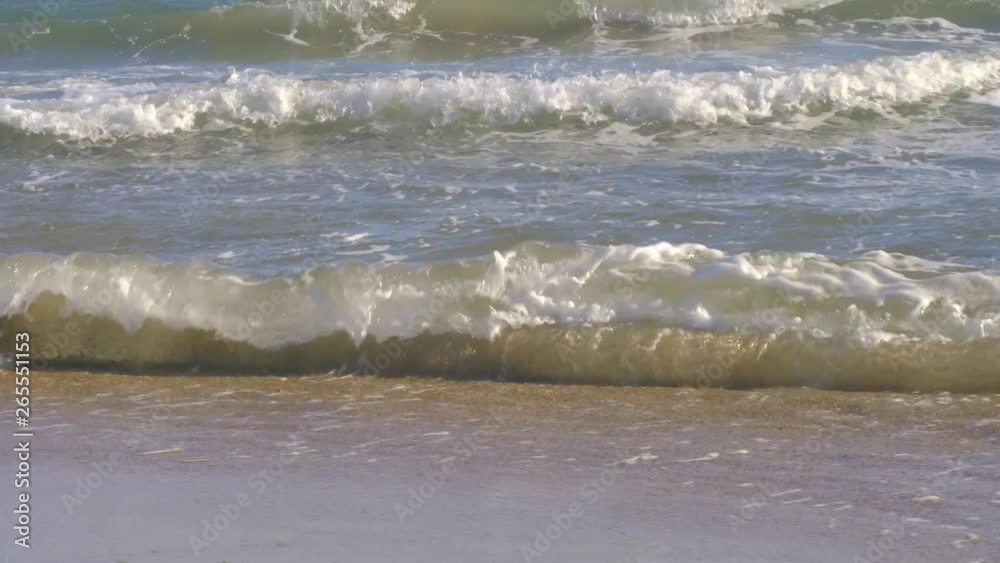 Sandy beach with small waves close up front view Sandy beach with small waves close up front view
