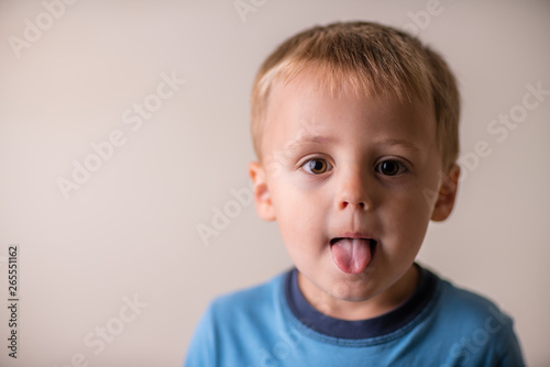 Cute boy sticking his tongue out