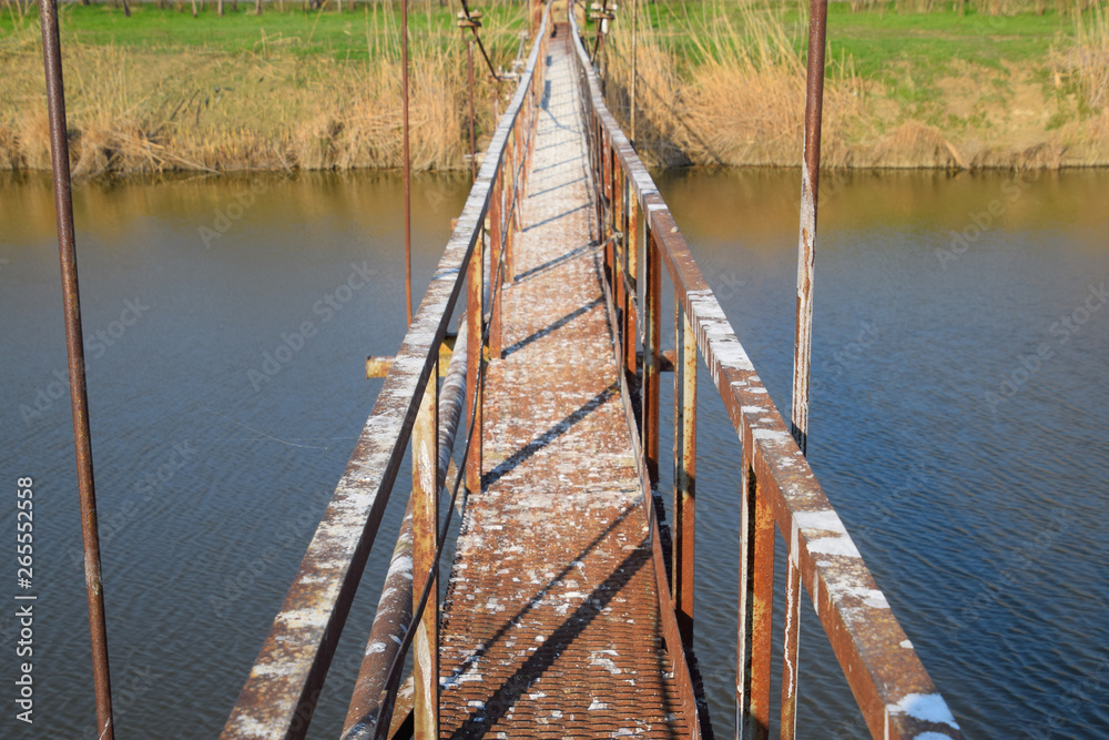 Steel bridge and gas pipeline through irrigation canal.