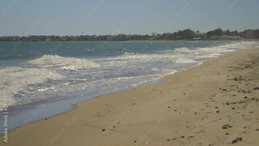 Sandy beach with small waves wide angle view. Sandy beach with small waves wide angle view.