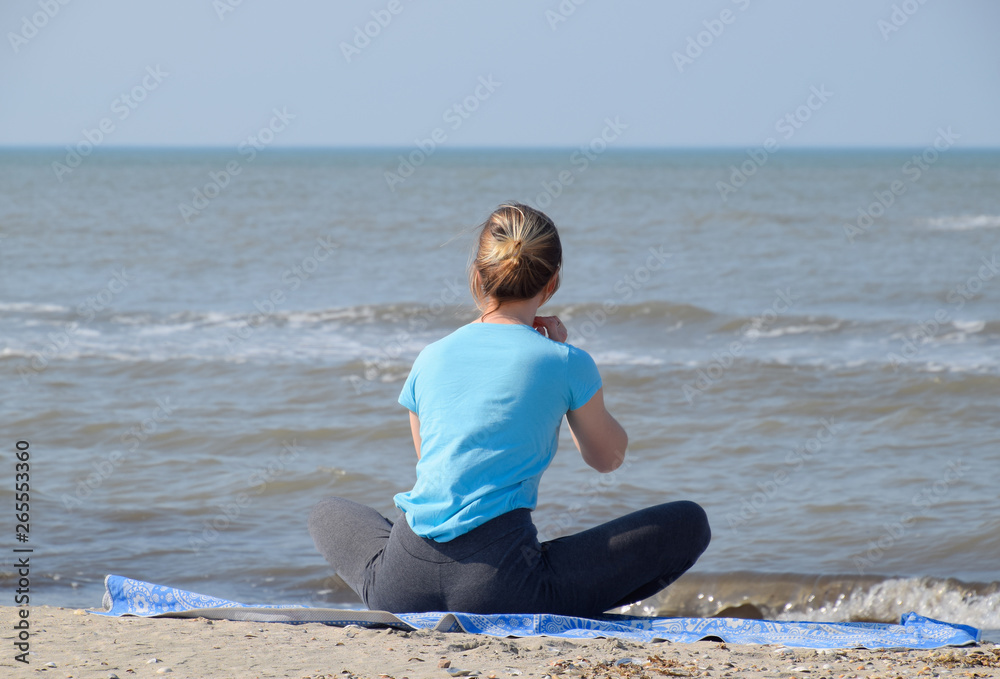girl practices yoga by the sea. Exercise gymnastics in the fresh air by the sea. girl practices yoga by the sea. Exercise gymnastics in the fresh air by the sea.