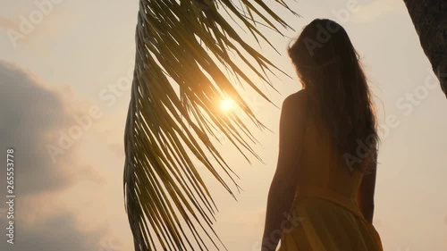 Young beautiful girl at sunset. Tropics. Palma. Sunset 4k