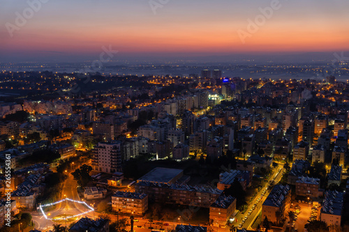 Aerial view of a residential neighborhood in a city during a vibrant and colorful sunrise. Taken in Netanya  Center District  Israel.