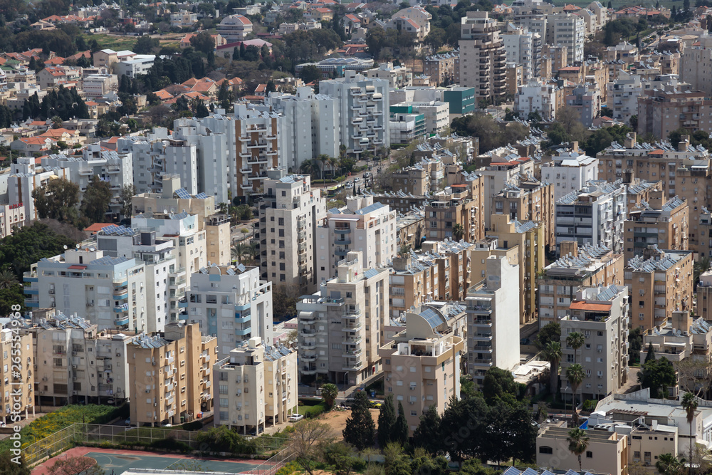 Aerial view of a residential neighborhood in a city during a cloudy and sunny day. Taken in Netanya, Center District, Israel.