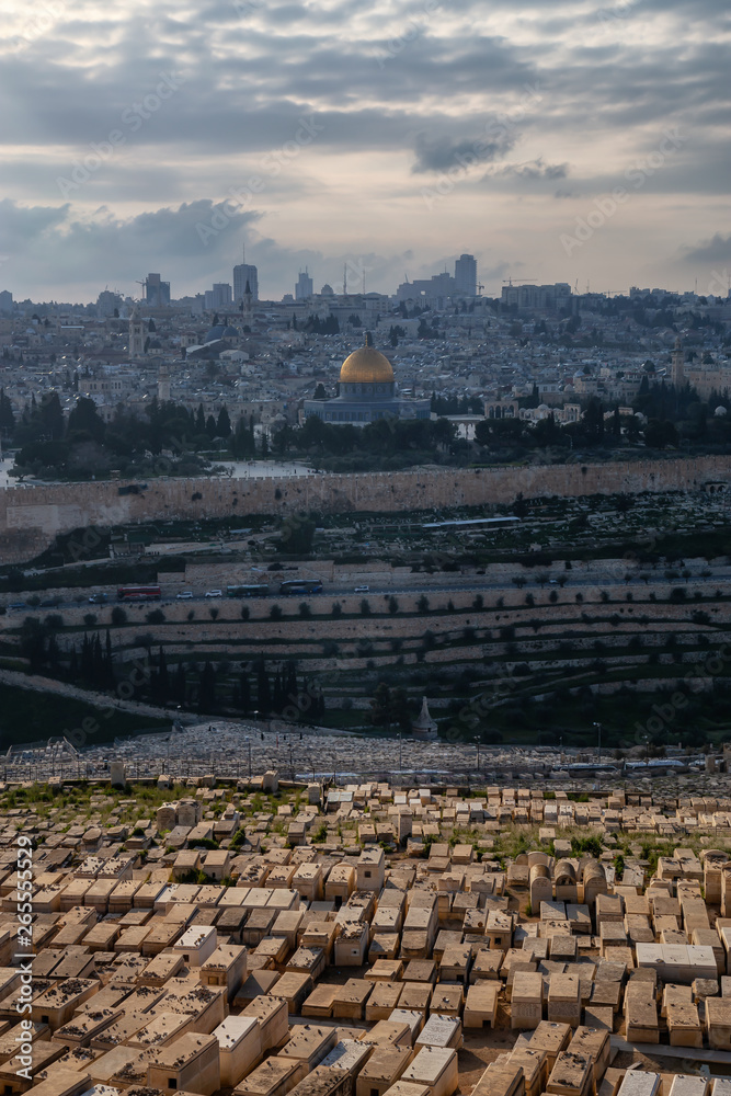 Fototapeta premium Beautiful aerial view of the Old City, Tomb of the Prophets and Dome of the Rock during a sunny and cloudy evening. Taken in Jerusalem, Capital of Israel.