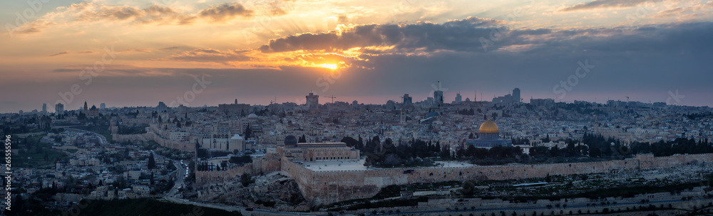 Beautiful panoramic aerial view of the Old City and Dome of the Rock during a dramatic colorful sunset. Taken in Jerusalem, Capital of Israel.