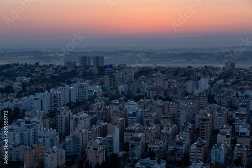 Aerial view of a residential neighborhood in a city during a vibrant and colorful sunrise. Taken in Netanya, Center District, Israel. © edb3_16