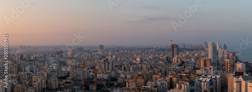 Aerial panoramic view of a residential neighborhood in a city during a vibrant and colorful sunrise. Taken in Netanya, Center District, Israel. © edb3_16