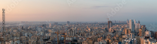 Aerial panoramic view of a residential neighborhood in a city during a vibrant and colorful sunrise. Taken in Netanya  Center District  Israel.