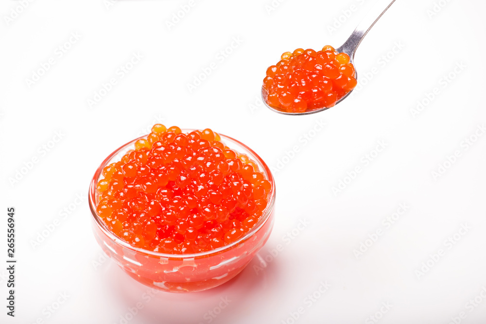 red caviar in glass bowl with spoon isolated on white background red caviar in glass bowl with spoon isolated on white background