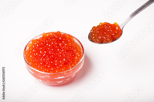 red caviar in glass bowl with spoon isolated on white background
