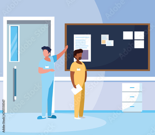 interracial male medicine workers in hospital corridor