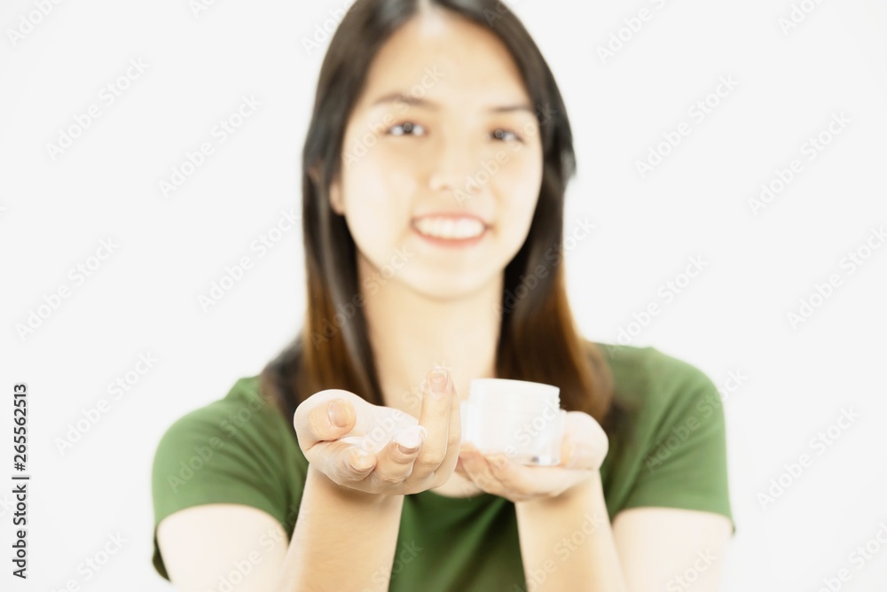 Young beautiful lady using moisturizer cream for face skin care - woman and cosmetic makeup face beauty skin care concept Young beautiful lady using moisturizer cream for face skin care - woman and cosmetic makeup face beauty skin care concept