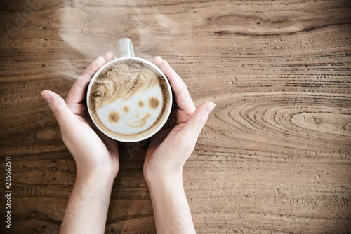 Hand holding hot coffee cup - people with coffee background concept